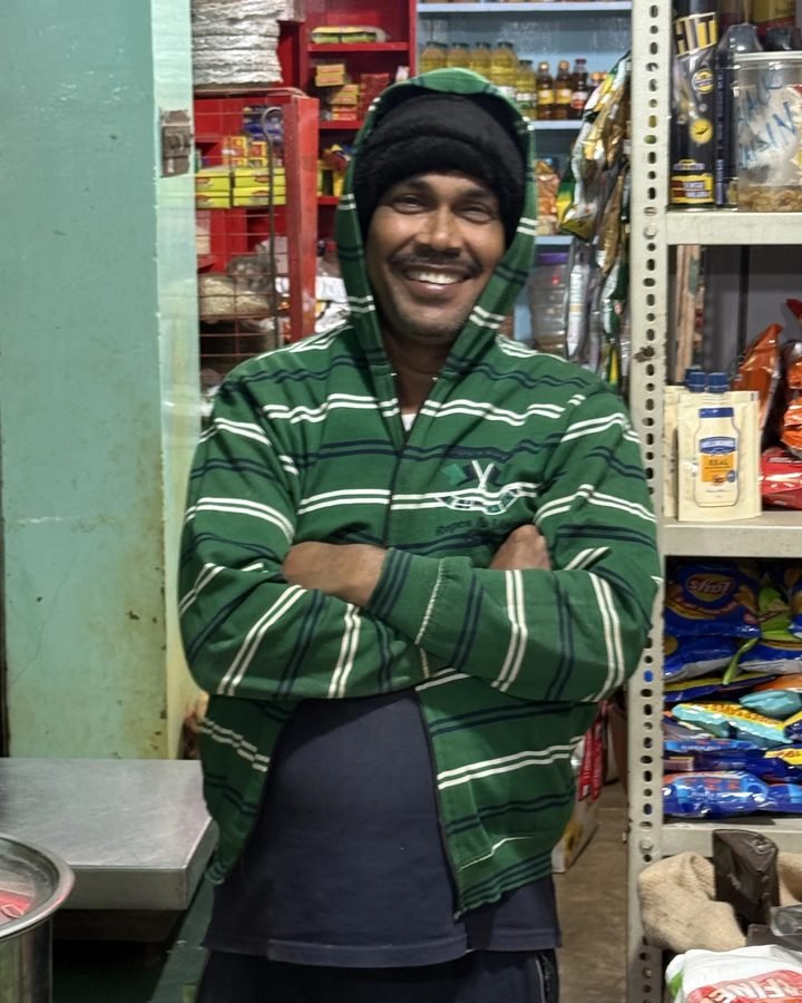 A member of the Ganapati team at the shop counter.