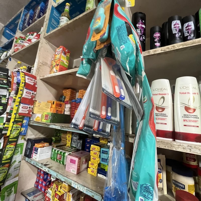 Personal and home care products on the shelves.